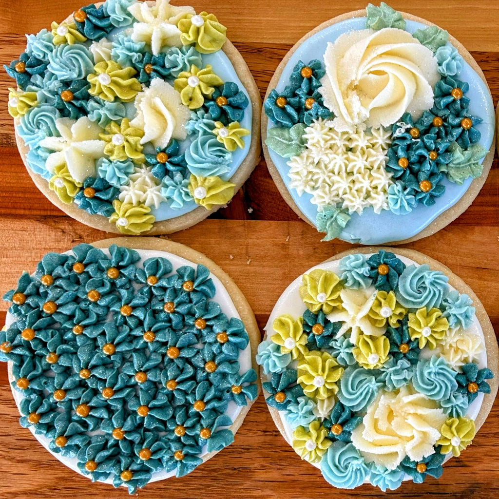 Decorative cookies with blue and white icing on a wooden surface
