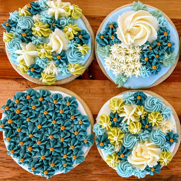 Decorative cookies with blue and white icing on a wooden surface