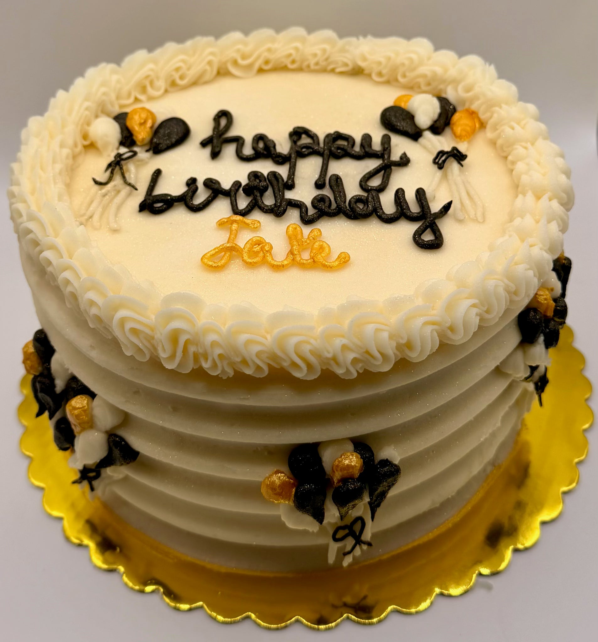 Funfetti Two-layer birthday cake with 'Happy Birthday Jake' on a gold plate with Balloon Decorated Sides