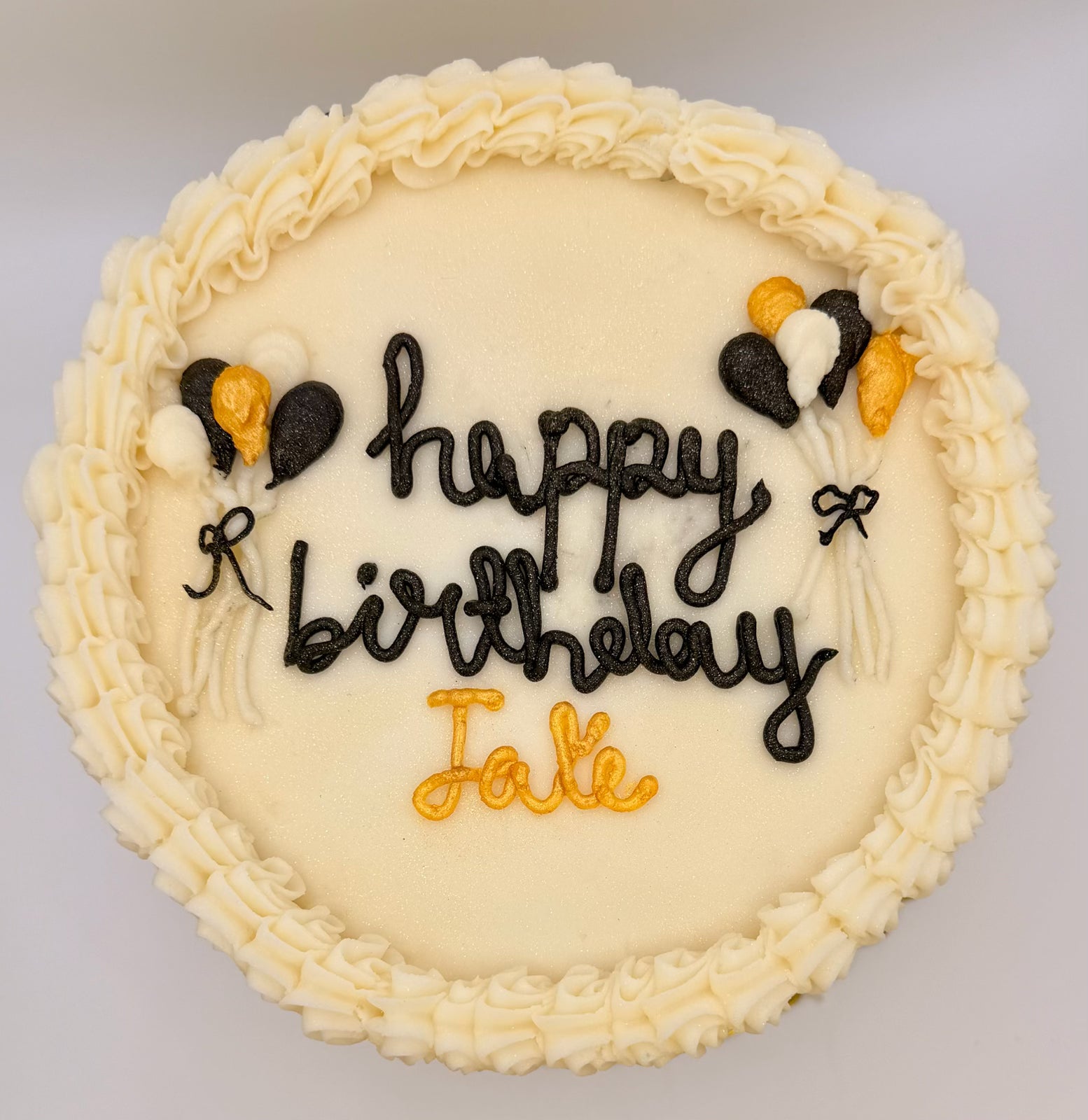 Funfetti Two-layer birthday cake with 'Happy Birthday Jake' on a gold plate with Balloon Decorated Sides